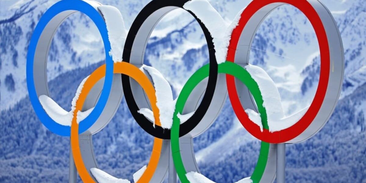 Olympics sign with snow covering it